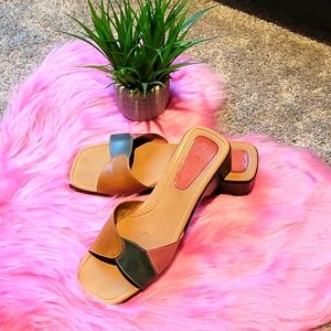 Gently used  women multi colored genuine leather slides.
